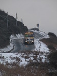 SX12143 Gritting truck driving through hillsides covered in snow.jpg